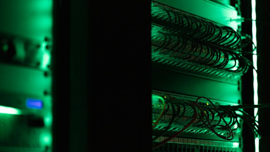Rows of electronic server equipment representing AI data-centre infrastructure.