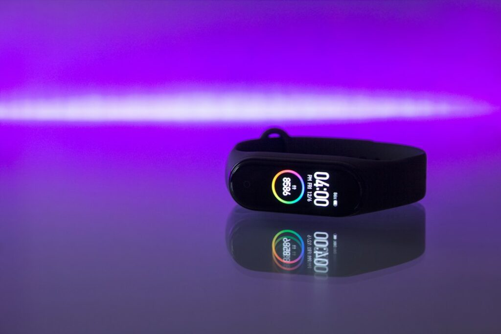 Black fitness tracker band photographed on a clean surface, illustrating screenless wearable tracking