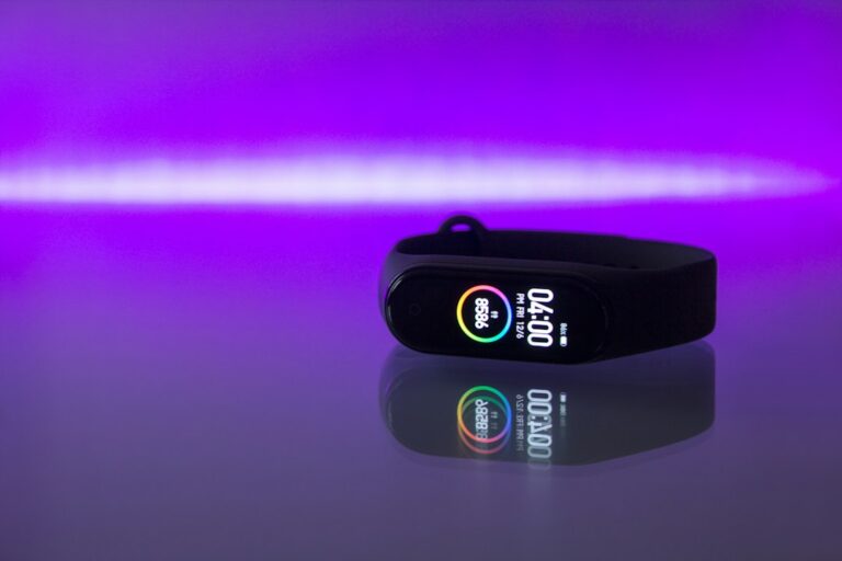 Black fitness tracker band photographed on a clean surface, illustrating screenless wearable tracking