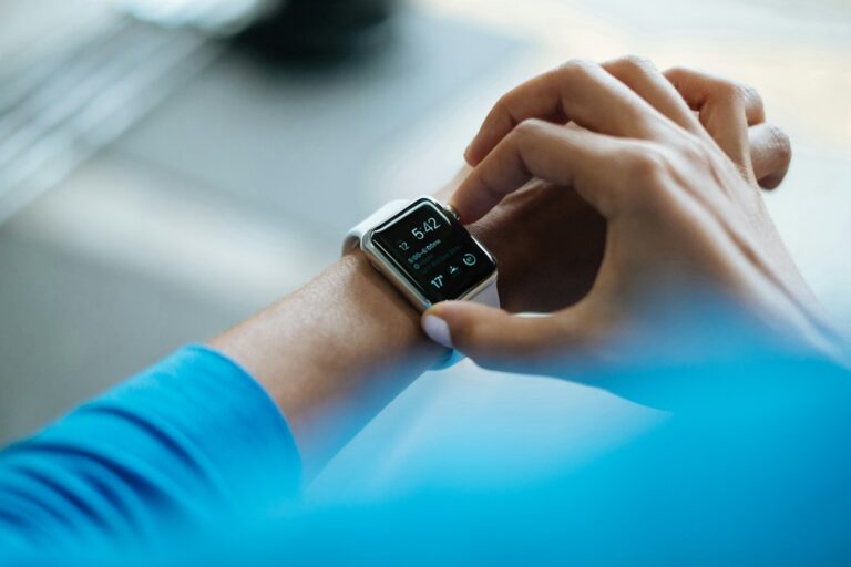 Illustrative photo of a person wearing a smartwatch; not a Fitbit Edge or Fitbit Air product image.