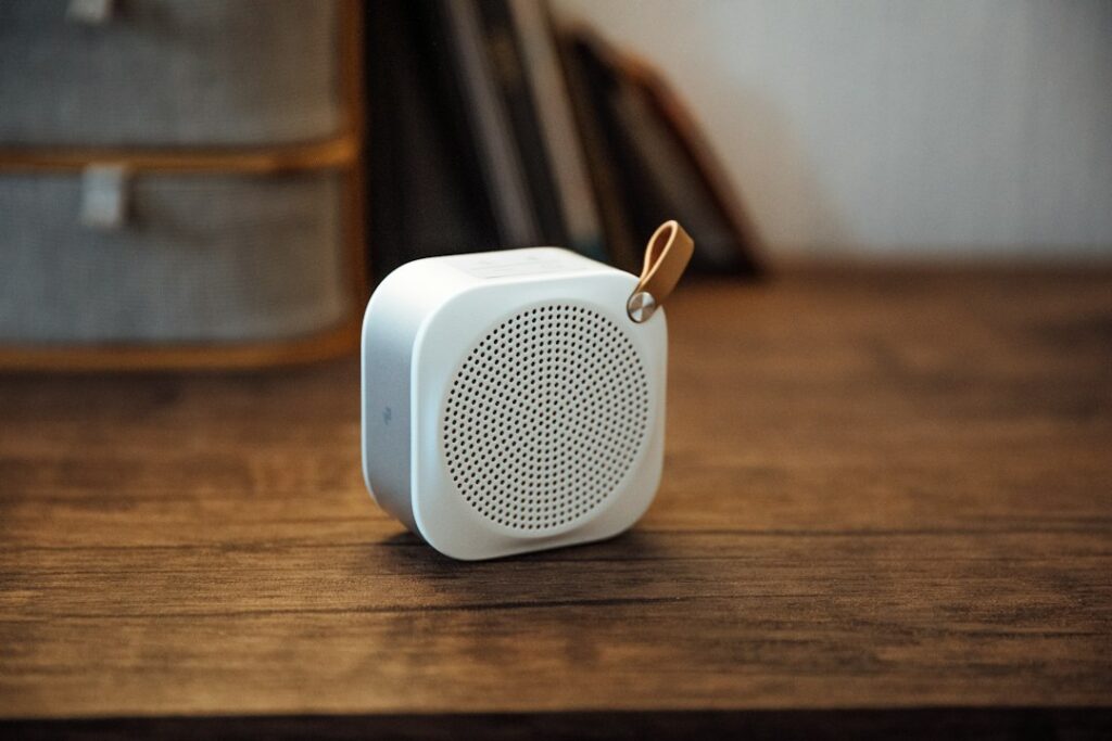 Illustrative portable Bluetooth speaker on a wooden table; not a CMF Speaker S or Speaker M product image.