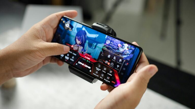 Gaming-focused smartphone photographed in a dark studio, illustrating mobile gaming heat and cooling accessories