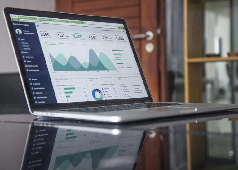 Laptop displaying business data and spreadsheet-style analytics for AI-assisted work