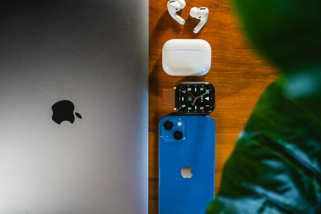 Apple laptop and AirPods representing AirPods Pro 3 and MacBook Air M5 deals