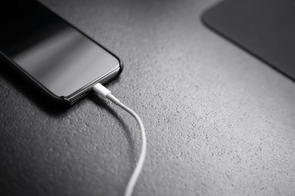 Smartphone connected to a charger