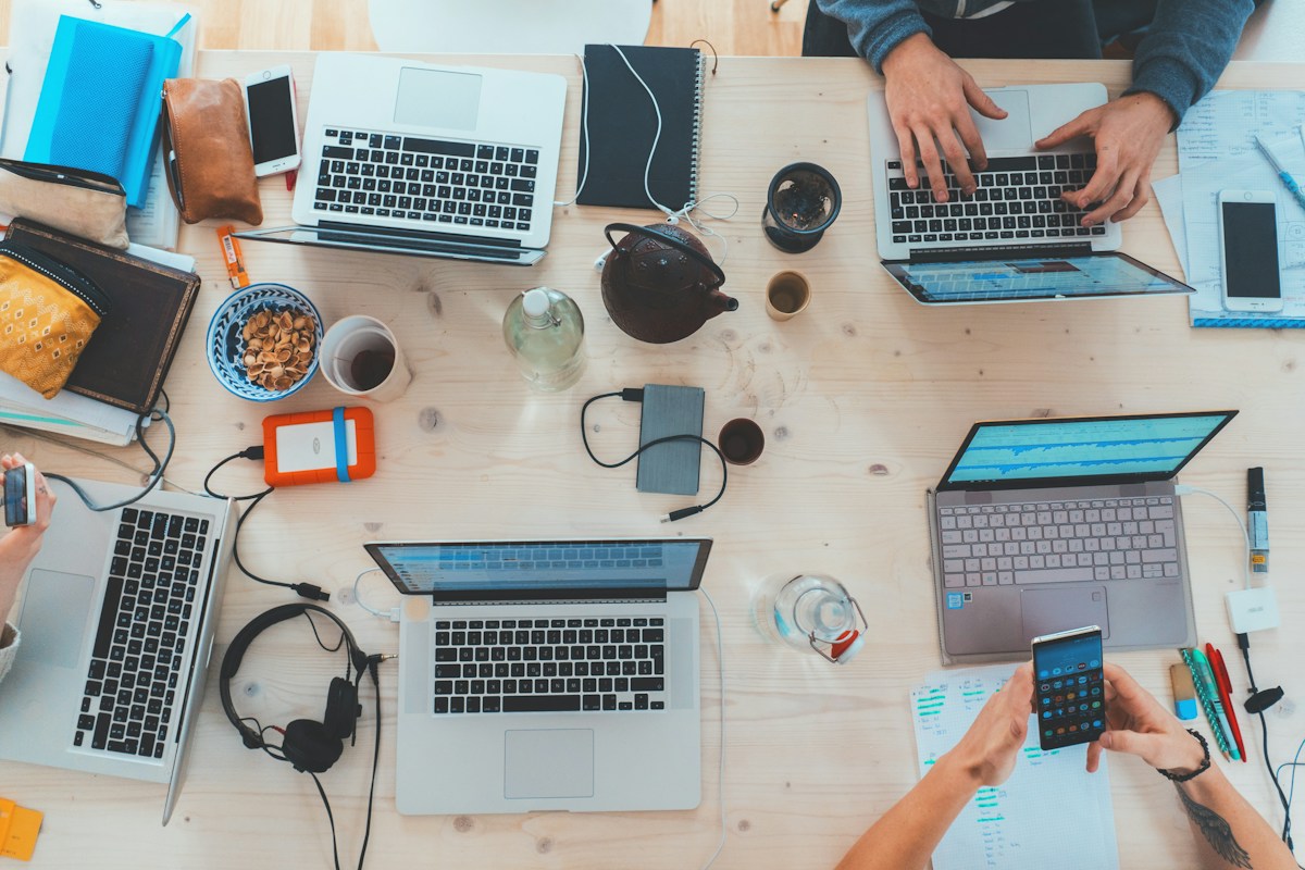 Professionals collaborating around computers and digital work tools